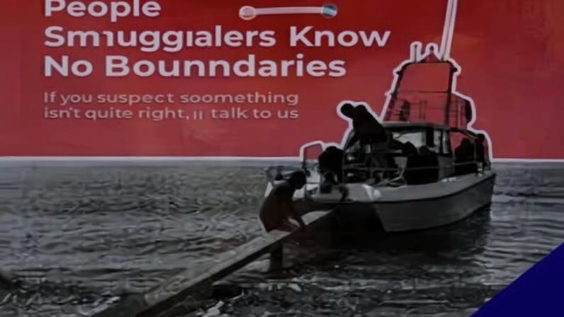 A people smuggling awareness poster at the seafront in Devon, UK. Photograph: Geoffrey Swaine/Rex/Shutterstock