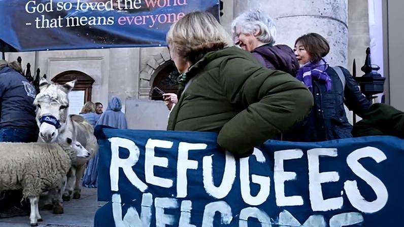 A pro-refugee demonstration outside St Martin-in-the-Fields church by Trafalgar Square, London, on 13 December 2025.