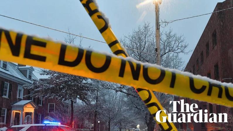 A police vehicle rests at an intersection near crime scene tape at Brown University, on Sunday, after a shooting left two dead and nine injured. Photograph: Steven Senne/AP