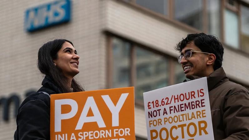 Demonstrators holding up placards outside St Thomas’ hospital in London on 17 December