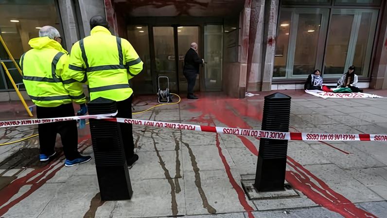 Red paint, intended to symbolise blood, flows from the Ministry of Justice building in central London.