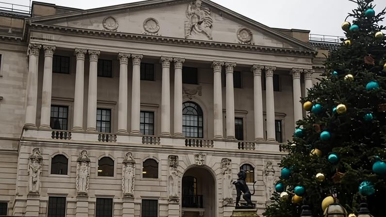 Exterior of the Bank of England with a large Christmas tree in the foreground