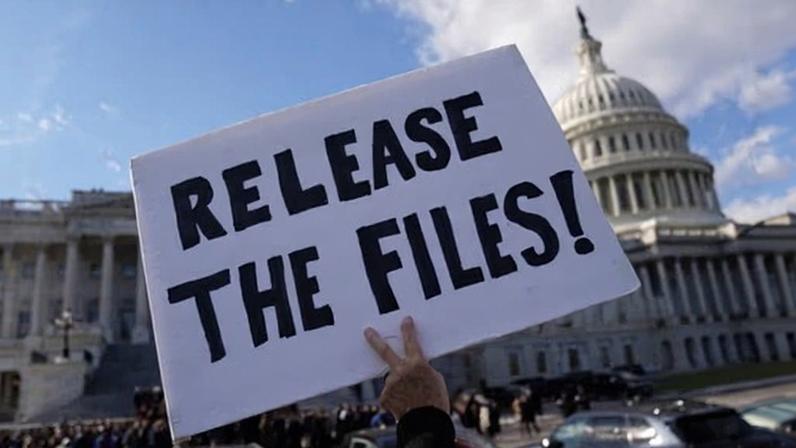 A protester holds a sign asking for the release of the Epstein files outside the US Capitol on 12 November 2025.