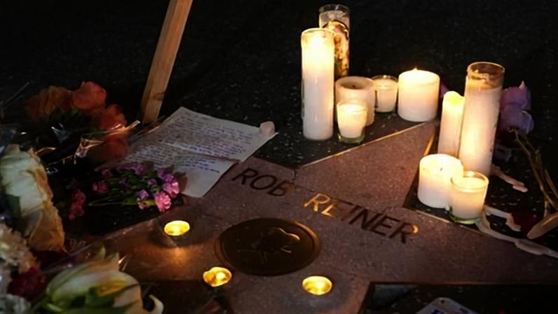 Flowers and candles are placed on Rob Reiner's star on the Hollywood Walk of Fame in Los Angeles on 15 December.