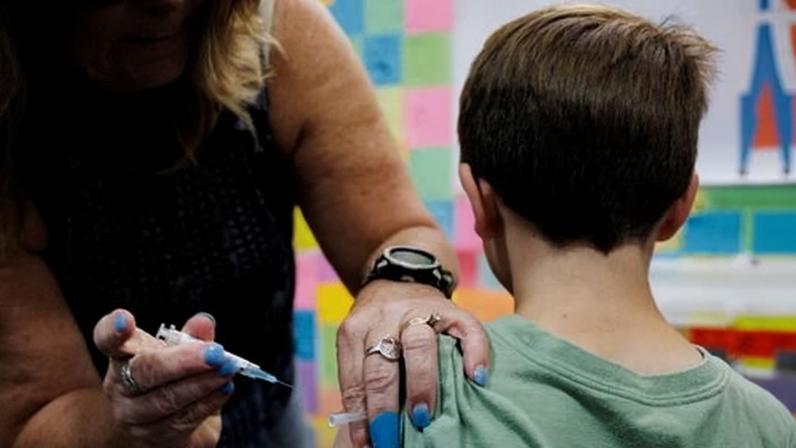 A child receives a dose of the Moderna Covid vaccine at Skippack Pharmacy in Schwenksville, Pennsylvania.
