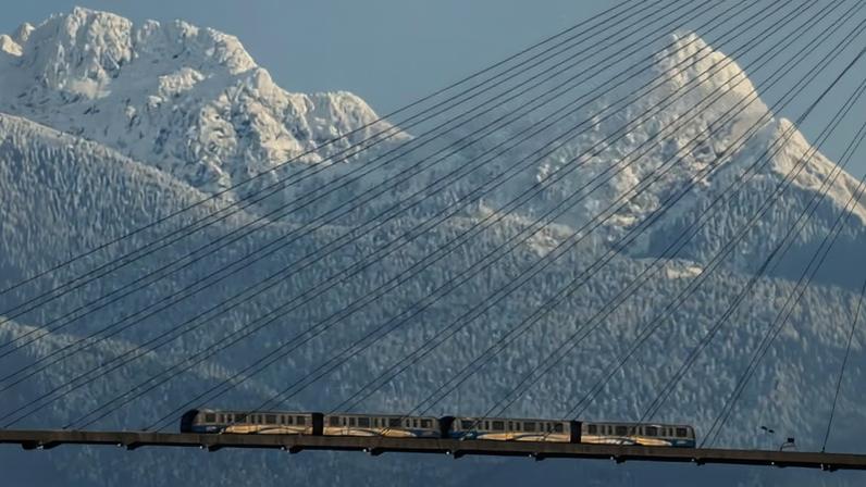 A Skytrain crosses over the Fraser River in New Westminster, British Columbia. More than foot of snowfall is expected above 1,800 in south-west BC. Photograph: Canadian Press/REX/Shutterstock