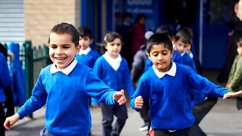 Children playing games in the school playground during dinner time at Feversham primary academy in Bradford, West Yorkshire. Photograph: Christopher Thomond/The Guardian