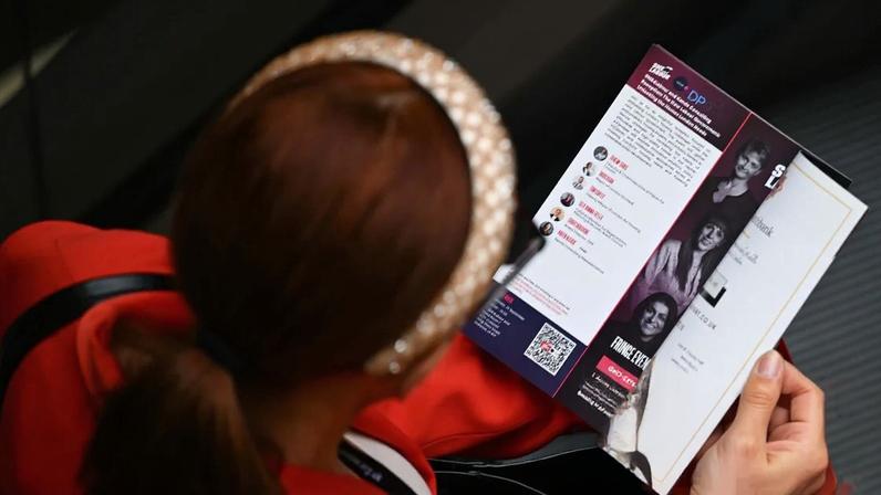 A woman looks at the brochure for the Labour party conference in Liverpool in September 2024. Photograph: Anadolu/Getty
