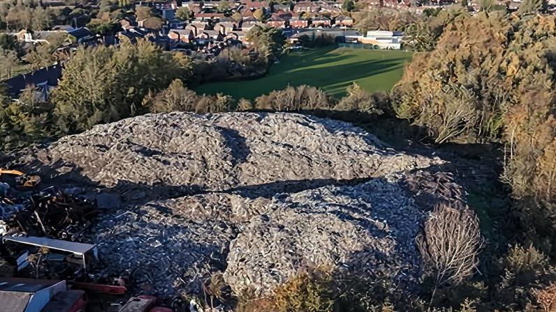 An aerial view of the 25,000 tonnes of waste that has been dumped near to residential homes in Bickershaw in Wigan, England.
