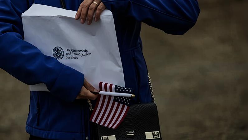 A new US citizen holds an envelope with her citizenship certificate in Alaska, on 10 August 2023. Photograph: John Moore/Getty Images