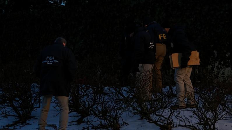 FBI agents investigate blocked off buildings at Brown University in Providence on Monday.