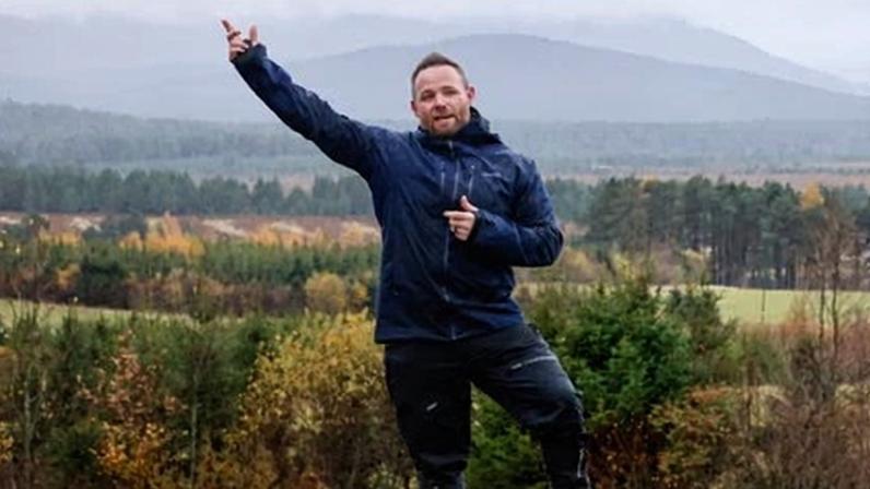 Rich Stockdale standing on rock in field