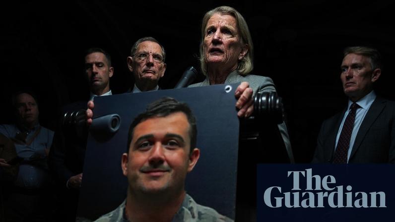 Shelley Moore Capito, a senator from West Virginia, holds up a photo of Andrew Wolfe at the US Capitol on 2 December 2025.