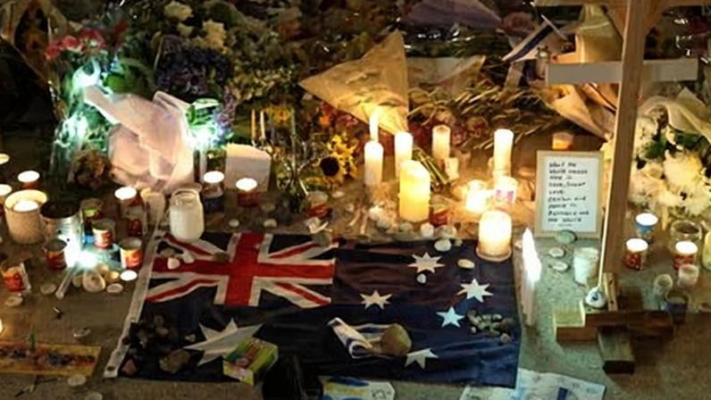 An Australian flag amid floral tributes in Bondi to the victims of Sunday’s terror attack.