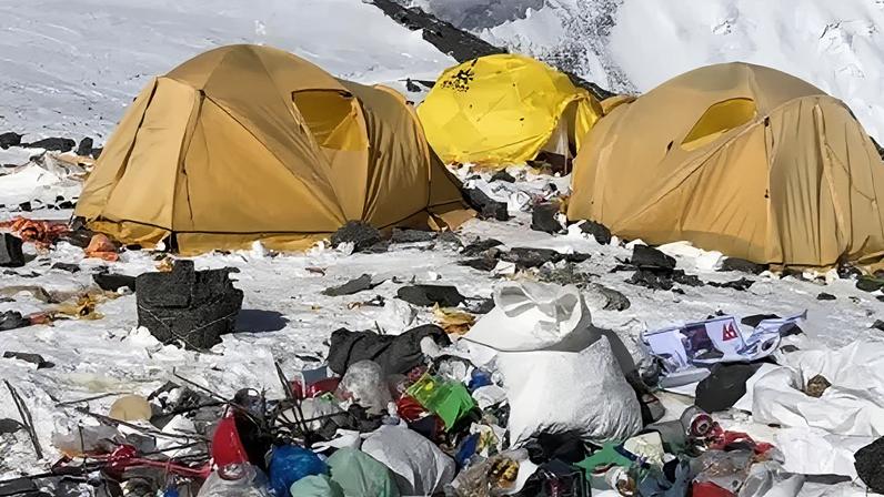 David Liano Camp IV on Everest. A cluster of yellow tents surrounded by snow and rubbish.