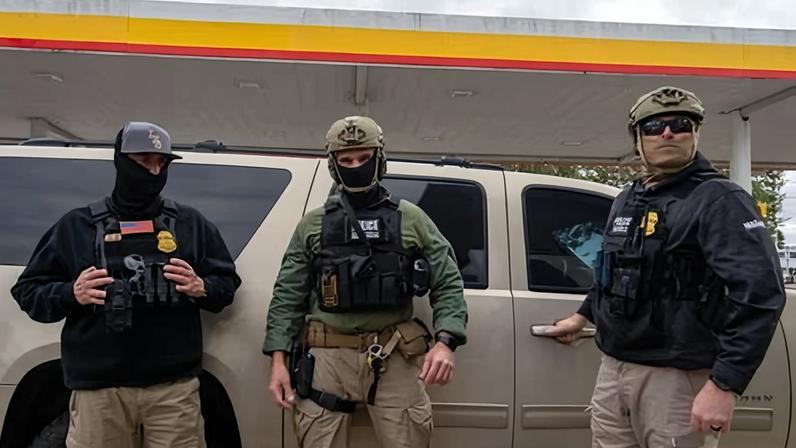 Customs and Border Protection (CBP) agents stand guard at a gas station in Metairie, Louisiana, on 3 December 2025.