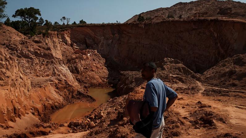 An employee of the Jiuxing Chinese mining company stands at a mining site on Oct. 7, 2016 in Soamahamanina, Madagascar.
