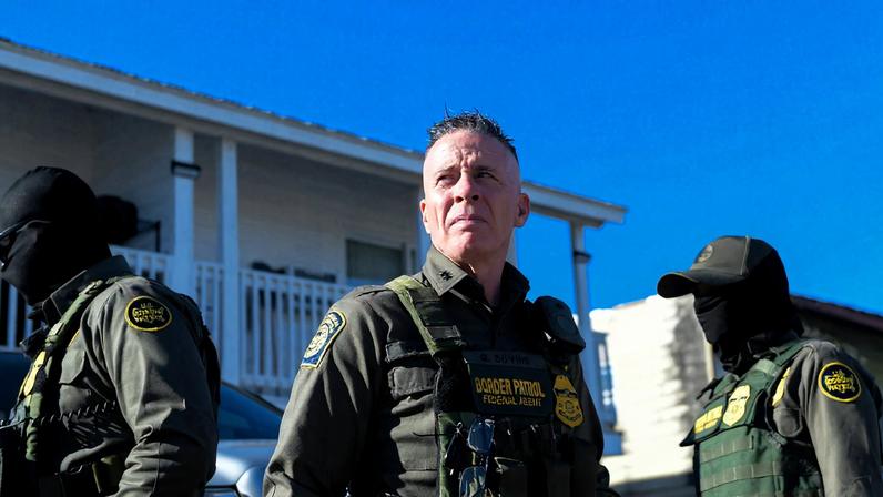 Border Patrol Commander Gregory Bovino walks with CBP and other law enforcement officers through a neighborhood in...