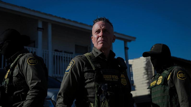 Border Patrol Commander Gregory Bovino walks with CBP and other law enforcement officers through a neighborhood in...