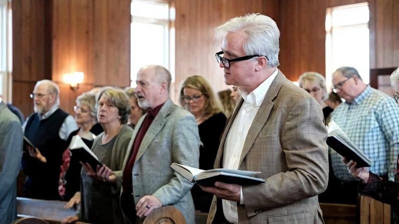 Members and visitors worship at the Cramer and Hanover Church of Christ during its final Sunday service.