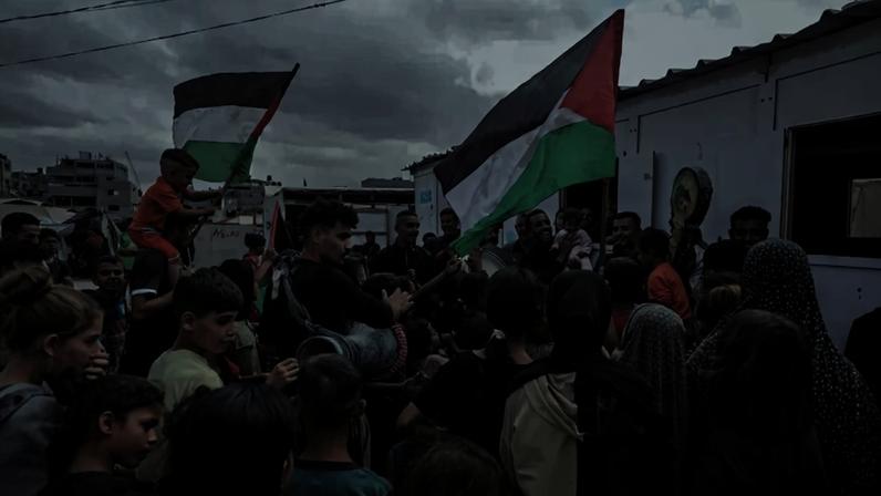 Palestinians at the Nuseirat refugee camp celebrate the announcement of the cease-fire agreement in Gaza on Oct. 9.
