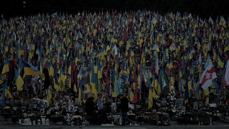 People mourn at the graves of Ukrainian service members in Lviv, Ukraine, on Dec. 6.