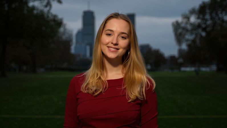 Julianna Schneider in Killian Court with Boston skyline in background