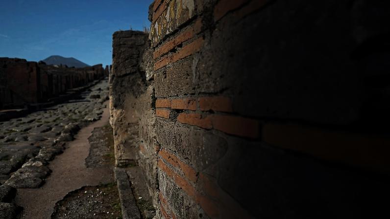 An ancient Pompeii wall at a newly excavated site, where Associate Professor Admir Masic applied compositional analysis (overlayed to right) to understand how ancient Romans made concrete that has endured for thousands of years.