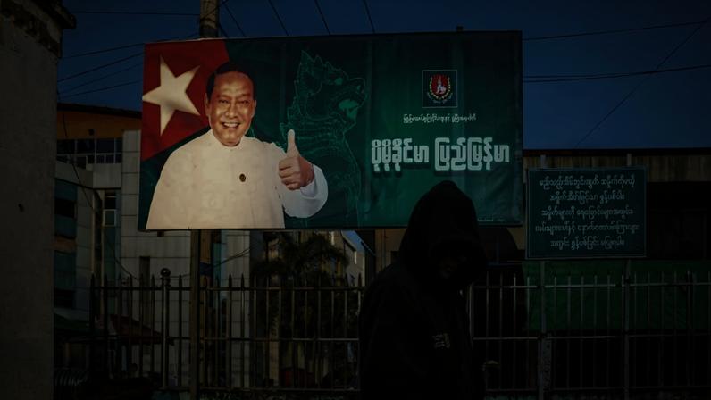 A man walks past a campaign billboard featuring Union Solidarity and Development Party Chairman Khin Yi in Lashio, Myanmar, on Dec. 20.