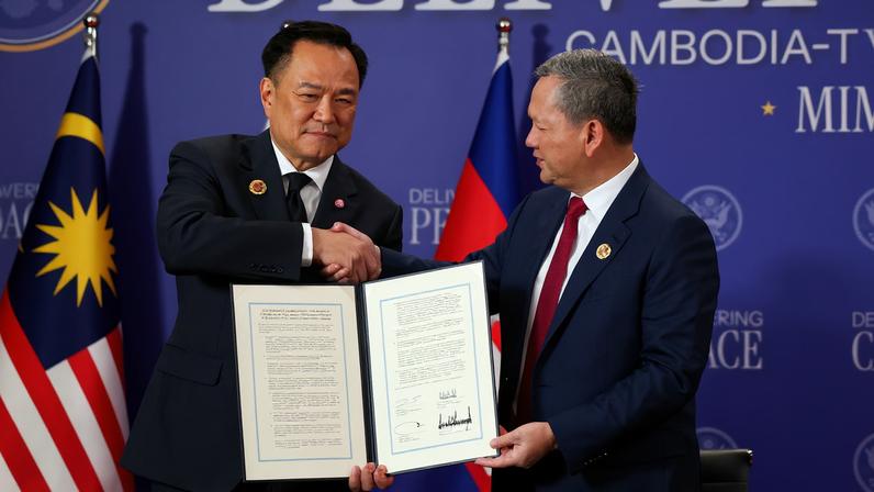 Thailand's Prime Minister Anutin Charnvirakul and Cambodia's Prime Minister Hun Manet shake hands and hold up a document, during the signing of a ceasefire deal between Cambodia and Thailand on the sidelines of the 47th Association of Southeast Asian Nations (ASEAN) summit in Kuala Lumpur, Malaysia, October 26, 2025.