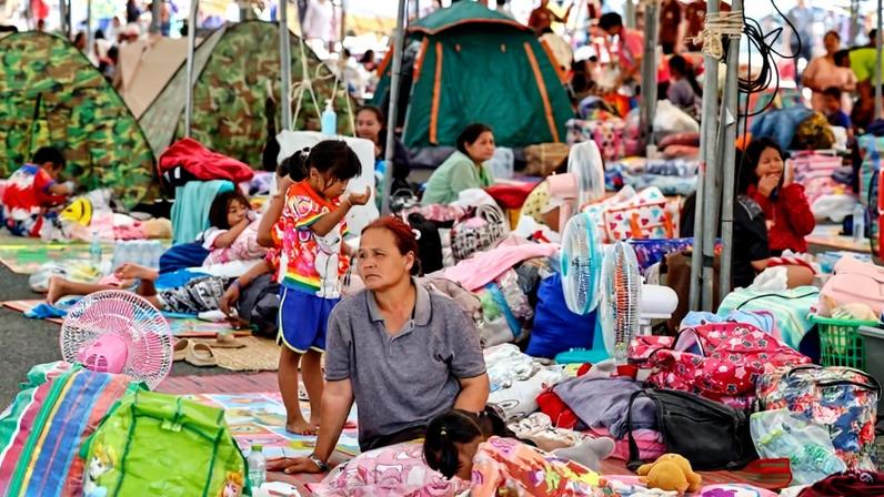 Evacuated Thai residents gather at a temporary shelter in Thailand.