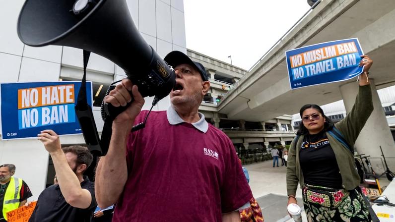 People participate in a travel ban protest in Los Angeles.