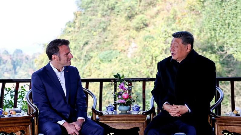Chinese President Xi Jinping speaks with French President Emmanuel Macron during a visit at the Dujiangyan site in southwestern China.