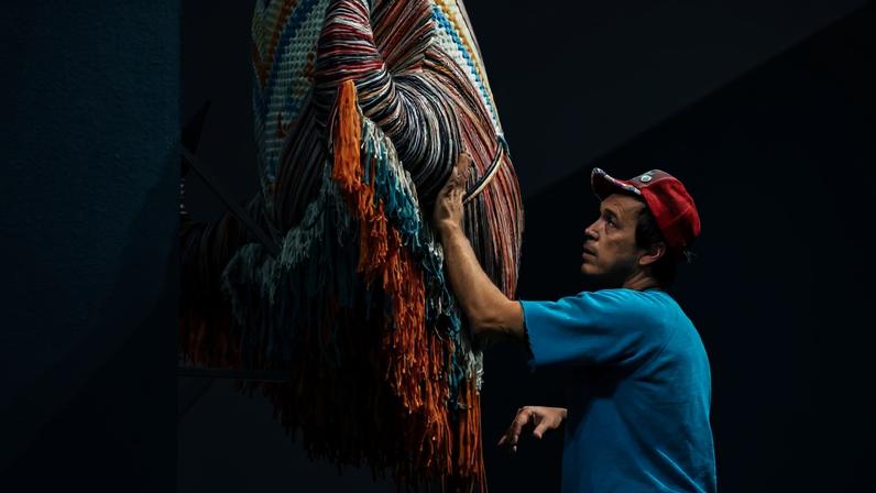 Cannupa Hanska Luger in the Joslyn's Temporary Exhibition Galleries Photograph by Shayla Blatchford (Diné), 2025