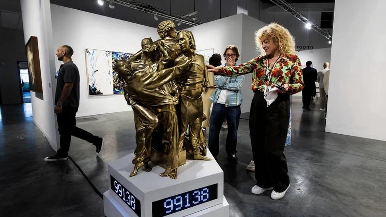 Fingerprints welcome: a fairgoer interacts with MSCHF’s sculpture at Perrotin