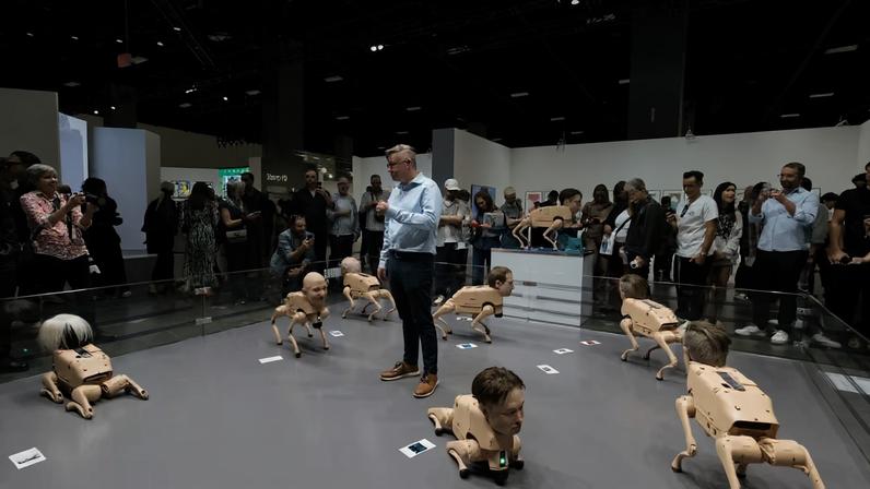 The artist Beeple (centre) discusses his robotic dog sculptures, which have been the talk of Art Basel Miami Beach Liliana Mora
