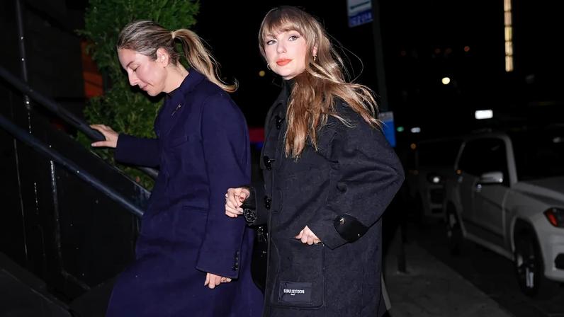 Taylor Swift wore a Louis Vuitton coat worth $6,400 as a minidress for her Tuesday night dinner in New York City's West Village. GC Images