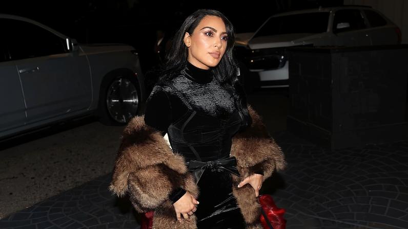 Kardashian’s holiday look was tied with a bow at the waist.