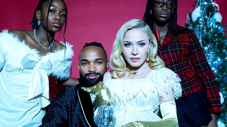 Madonna, 67, shared a sultry holiday photo shoot on Instagram Tuesday, posing in lingerie alongside boyfriend Akeem Morris, 29, and twin daughters Stella and Estere, 13.