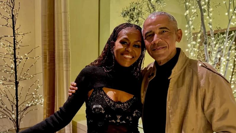 Michelle Obama and Barack Obama posed for a smiling Christmas photo on Thursday.