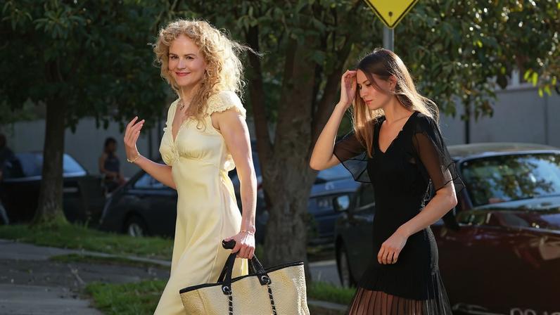 Nicole Kidman in a silk dress with a Chanel bag and her daughter in a black dress in Sydney.