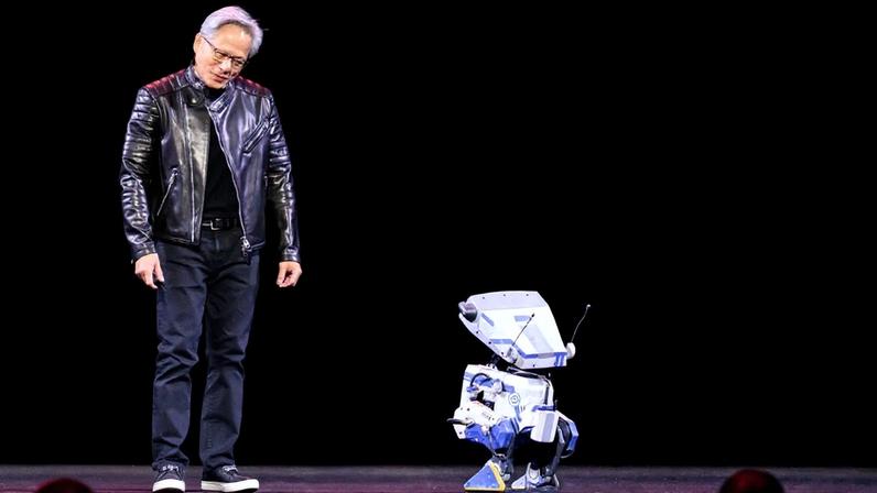 Nvidia CEO Jensen Huang talks to a robot during a keynote session at the SAP Center in San Jose, California, on March 18.