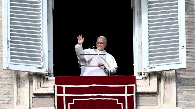Pope Leo XIV addresses the crowd from the window of the apostolic palace overlooking St.Peter's square during his Sunday Angelus prayer at the Vatican on January 1, 2026. (Photo by Alberto PIZZOLI / AFP)