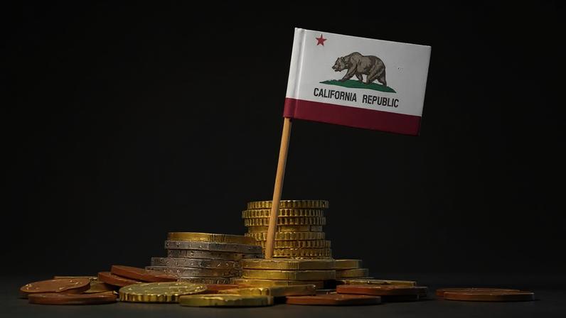 Flag of California in a mixed stack of european coins and a blue background.(series)