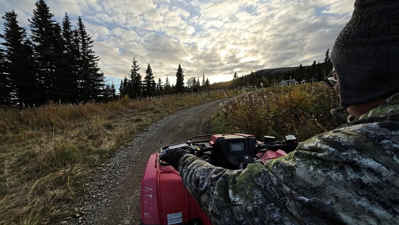 Clarence Saccheus rides past the village cemetery in Elim, Alaska, in September 2025.