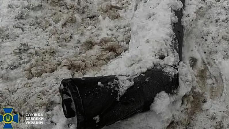 Piece of the Oreshnik missile that hit Lviv lies partly buried in snow.
