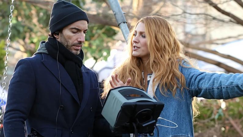 Blake Lively filming "It Ends With Us" in New York City, wearing a denim coat with a white fur collar, blue pants, and red boots.