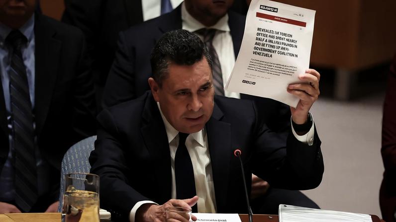 Venezuela Ambassador to the United Nations Samuel Reinaldo Moncada Acosta speaks as he holds up a news article, during a UN Security Council meeting on U.S. strikes and the capture of Venezuelan President Nicolas Maduro and his wife Cilia Flores, at the United Nations headquarters in New York, U.S., January 5, 2026. REUTERS/Brendan McDermid