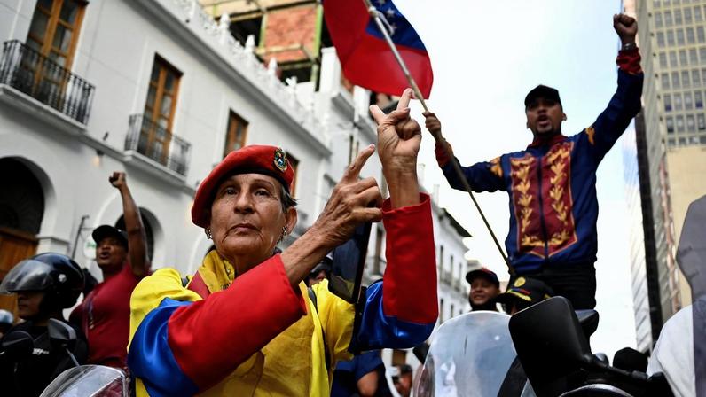 Demonstrators participate in a march outside the National Assembly on the day Vice President Delcy Rodriguez was formally sworn in as Venezuela's interim president, as U.S.-deposed President Nicolas Maduro appeared in a New York court after the Trump administration removed him from power, in Caracas, Venezuela January 5, 2026. REUTERS/Maxwell Briceno