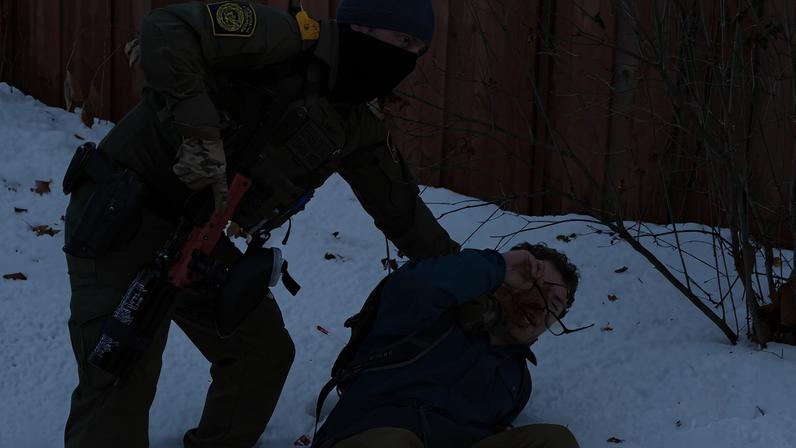 A member of U.S. Immigration and Customs Enforcement (ICE) restrains a protester trying to block vehicles from leaving the scene after a driver of a vehicle was shot in Minneapolis, Minnesota, U.S., January 7, 2026. REUTERS/Tim Evans TPX IMAGES OF THE DAY